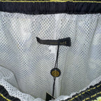 White mesh shorts with “VERSACE” label at waistband, textured fabric and scalloped trim