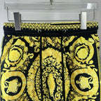 Black and yellow baroque print shorts close view of elastic waistband and drawstring