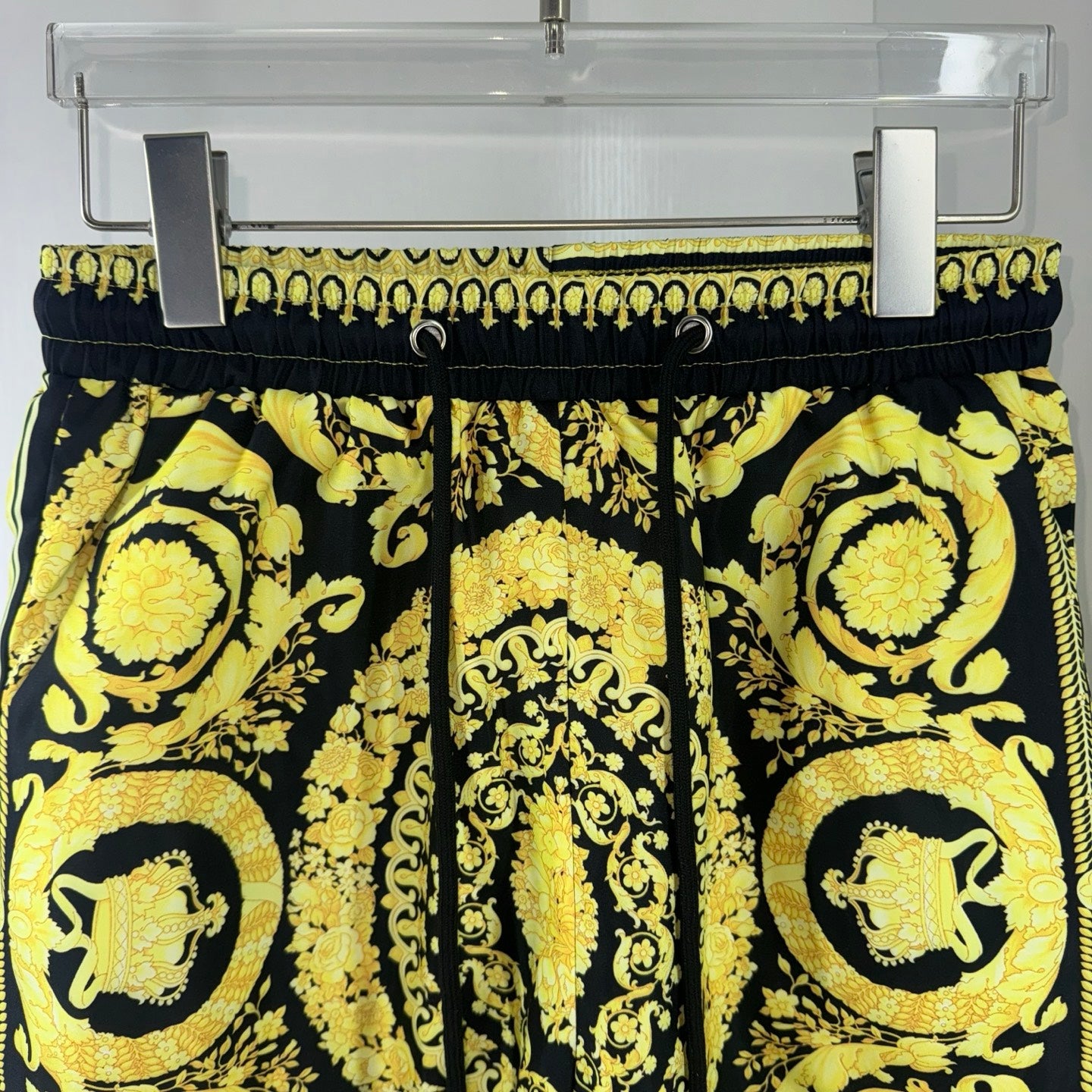 Black and yellow baroque print shorts close view of elastic waistband and drawstring