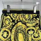 Versace printed skirt with black waistband and ornate gold medallion pattern