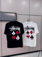 Black and white short-sleeve T-shirts with playing-card graphic on hangers