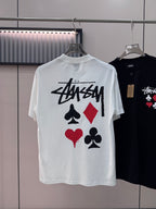 White short-sleeve T-shirt with Stussy graphic and playing-card symbols on chest