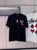 Black short-sleeve T-shirt with playing-card graphic on chest, on hanger