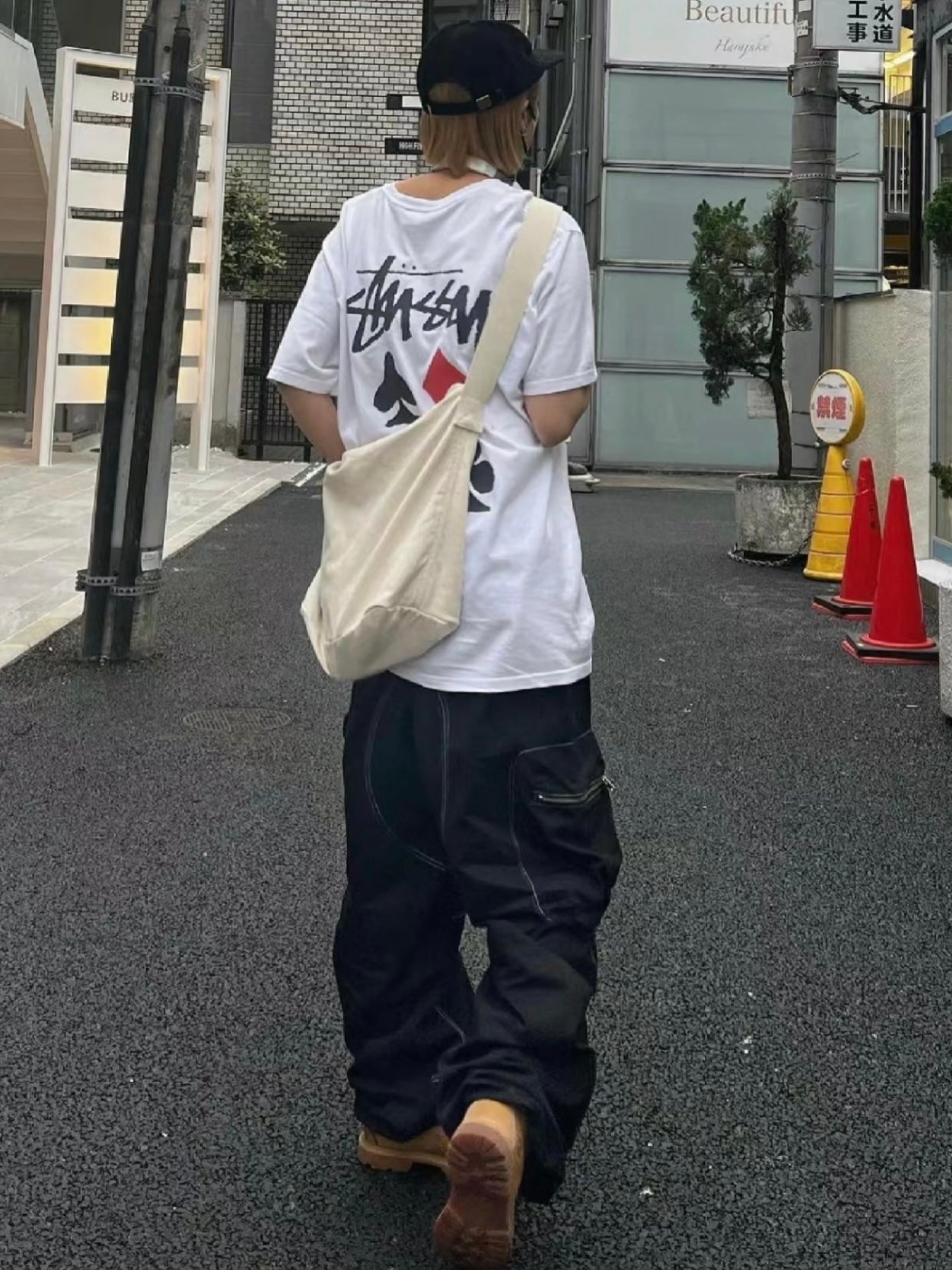 White graphic T-shirt with Stussy-style logo and diagonal hand-drawn print
