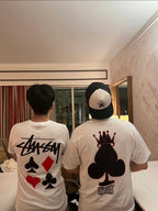 Pair of white graphic T-shirts with playing card motif on back