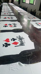 Pack of white graphic T-shirts with playing card icons and Stussy-style script