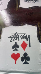 White graphic T-shirt with Stussy-style script and red/black playing card icons