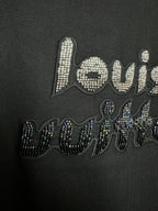 Close-up of black T-shirt chest graphic with rhinestone "louis" text