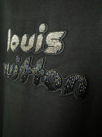 Close-up of black T-shirt rhinestone "world" text graphic