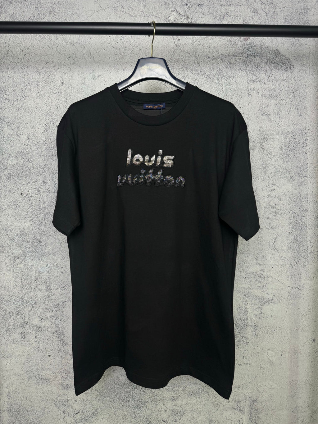 Black short-sleeve T-shirt with rhinestone "louis" graphic on the front