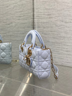 Light blue quilted mini handbag with top handles and gold-tone chain strap