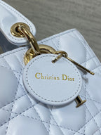 Quilted light blue handbag charm with Christian Dior logo and gold clasp