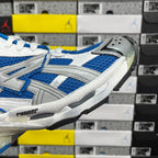 Side view of white and blue chunky sneakers with gray rubber toe guard and sole