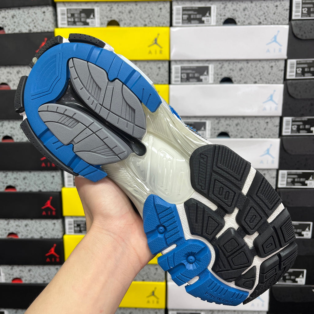 Shoe outsole with blue traction tread and gray rubber segments