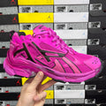 Pink athletic sneaker with black side stripes, perforated panels, and lace-up closure