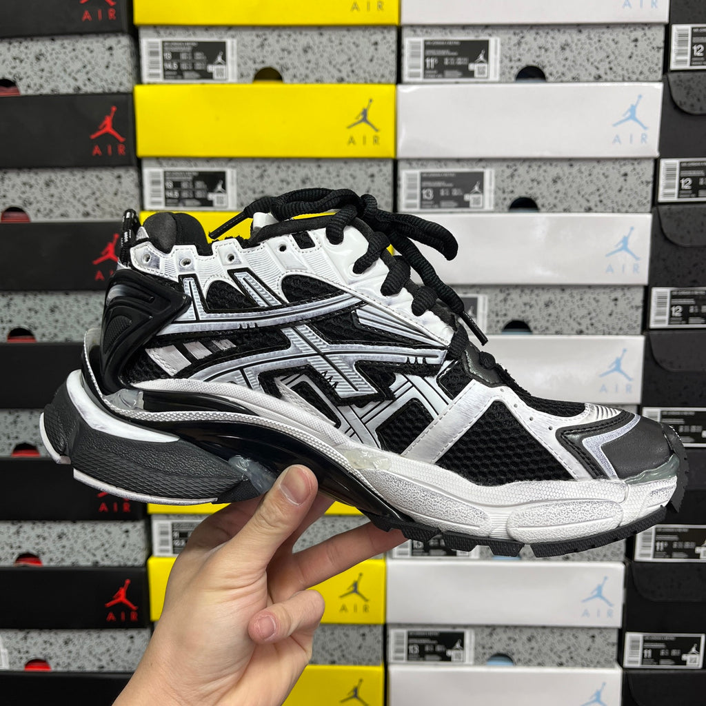 Black and white lace-up sneakers with chunky silver-toned sole and paneling