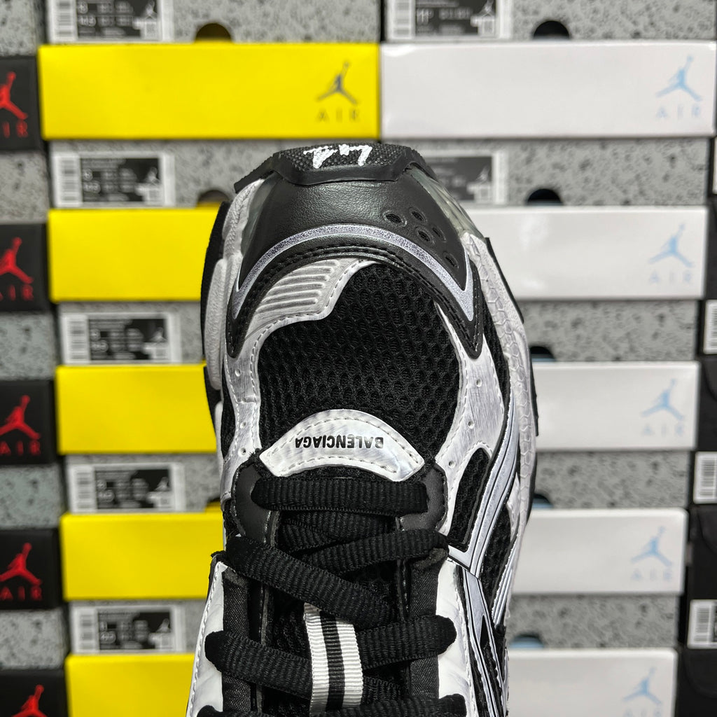 Black and white sneaker tongue and collar with black lace-up closure