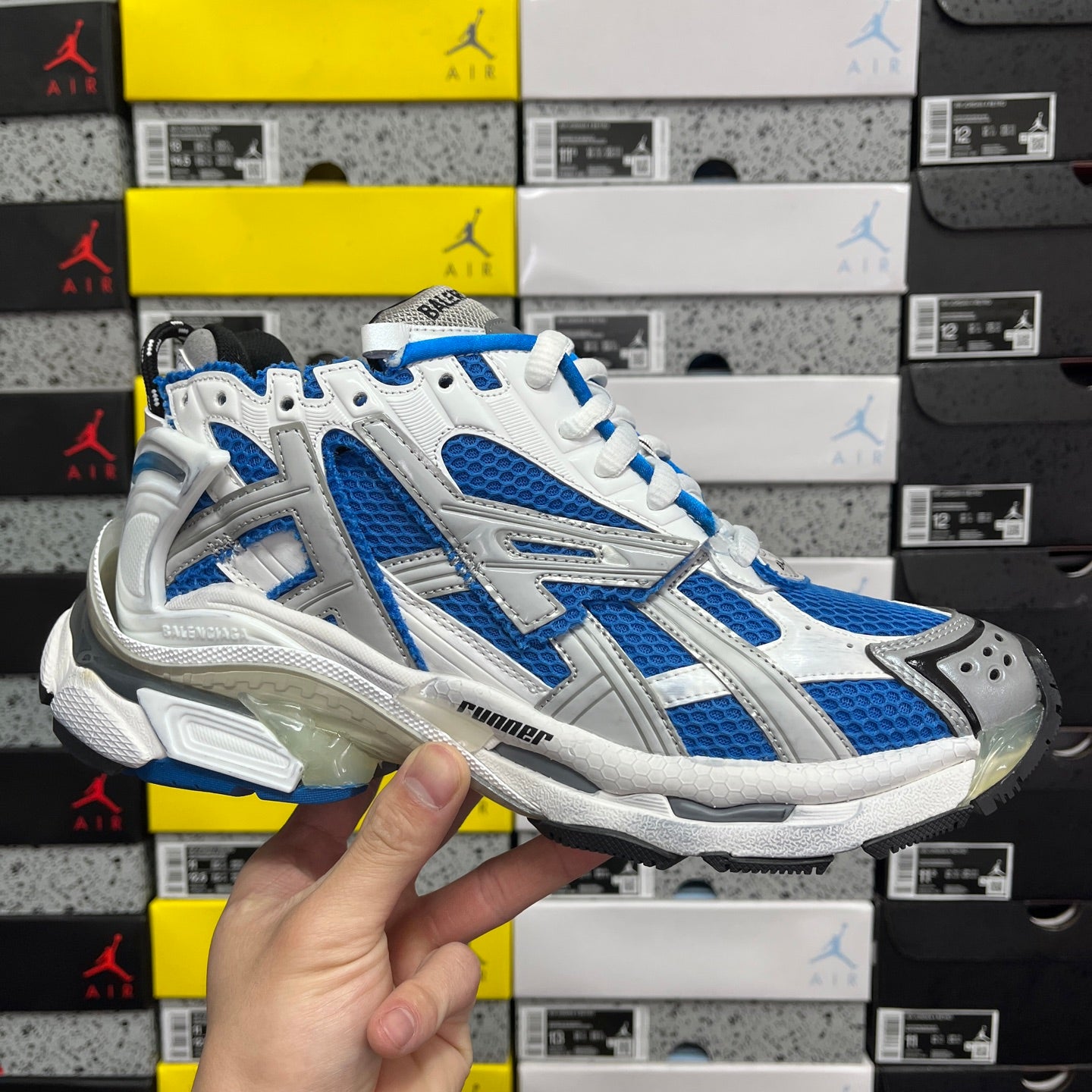 Blue and white chunky runner sneakers with white laces and padded heel collar