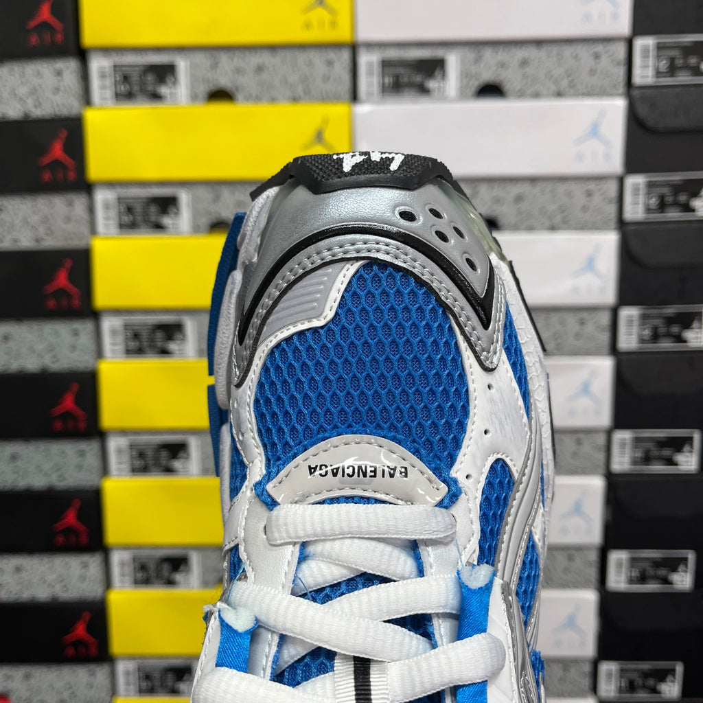 Blue and white sneaker upper with lace-up front and perforated gray toe panel