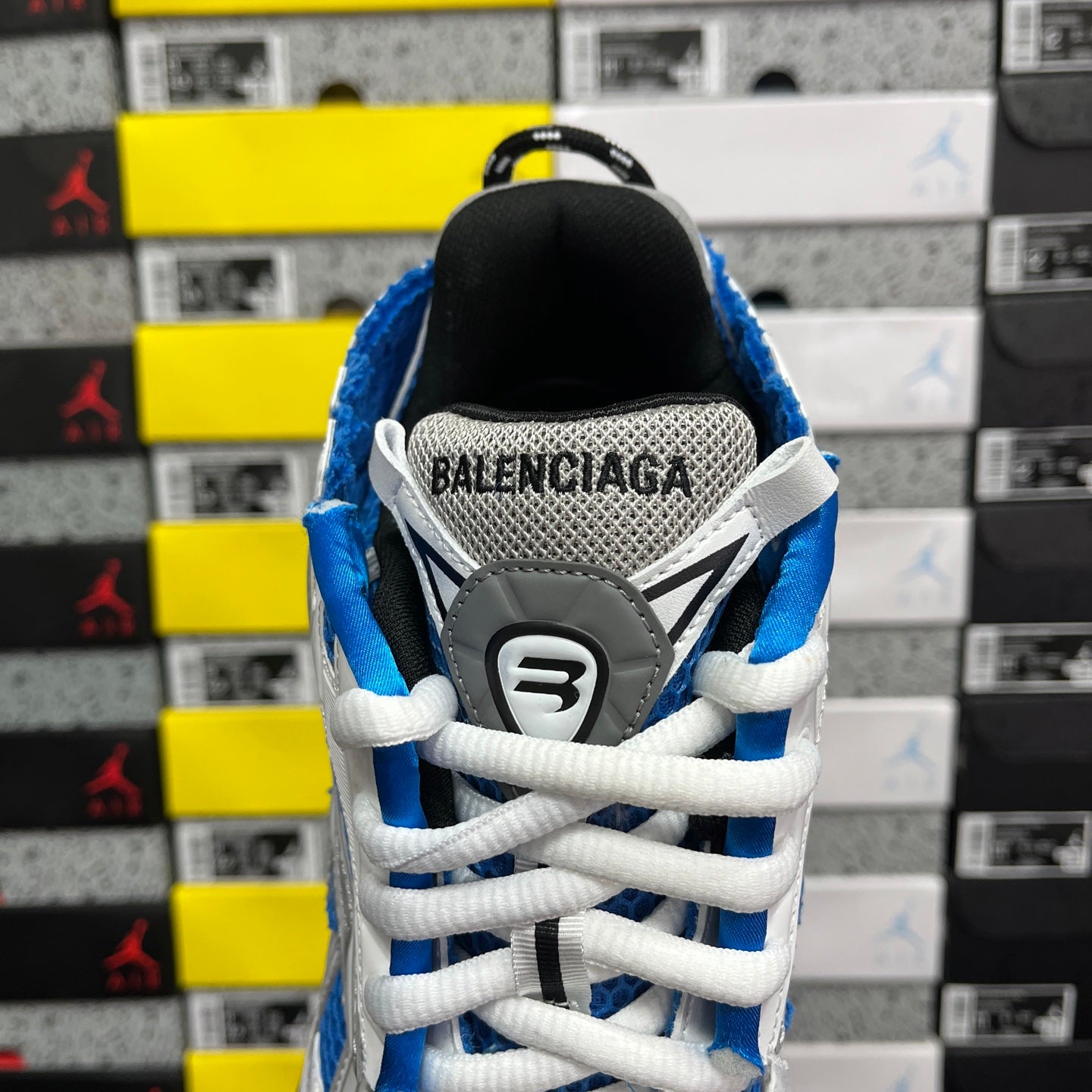 Rear view of Balenciaga sneakers with blue collar and black heel counter detail