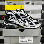 Black and white chunky sneakers with mesh panels, black laces, and sporty sole