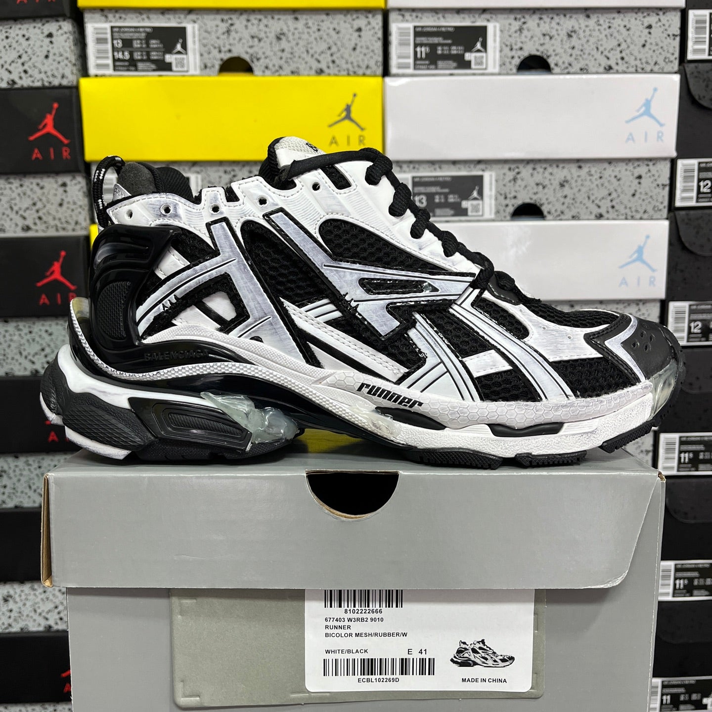 Black and white chunky sneakers with mesh panels, black laces, and sporty sole