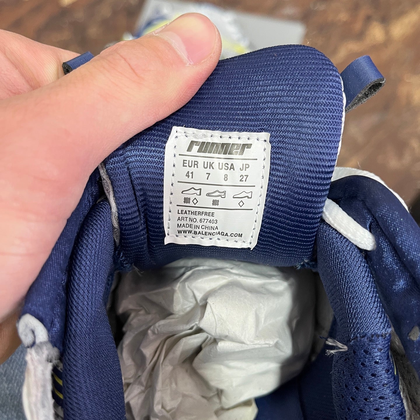 Unisex runner shoes size label on blue fabric tongue, white label with size info