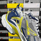 Unisex runner shoes angled side view, silver upper with navy heel and yellow-green trim