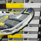 Unisex runner shoe side view, silver textured upper with blue and yellow-green stripes