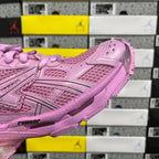 Pink sneaker side panel with perforated mesh texture and strap detail.