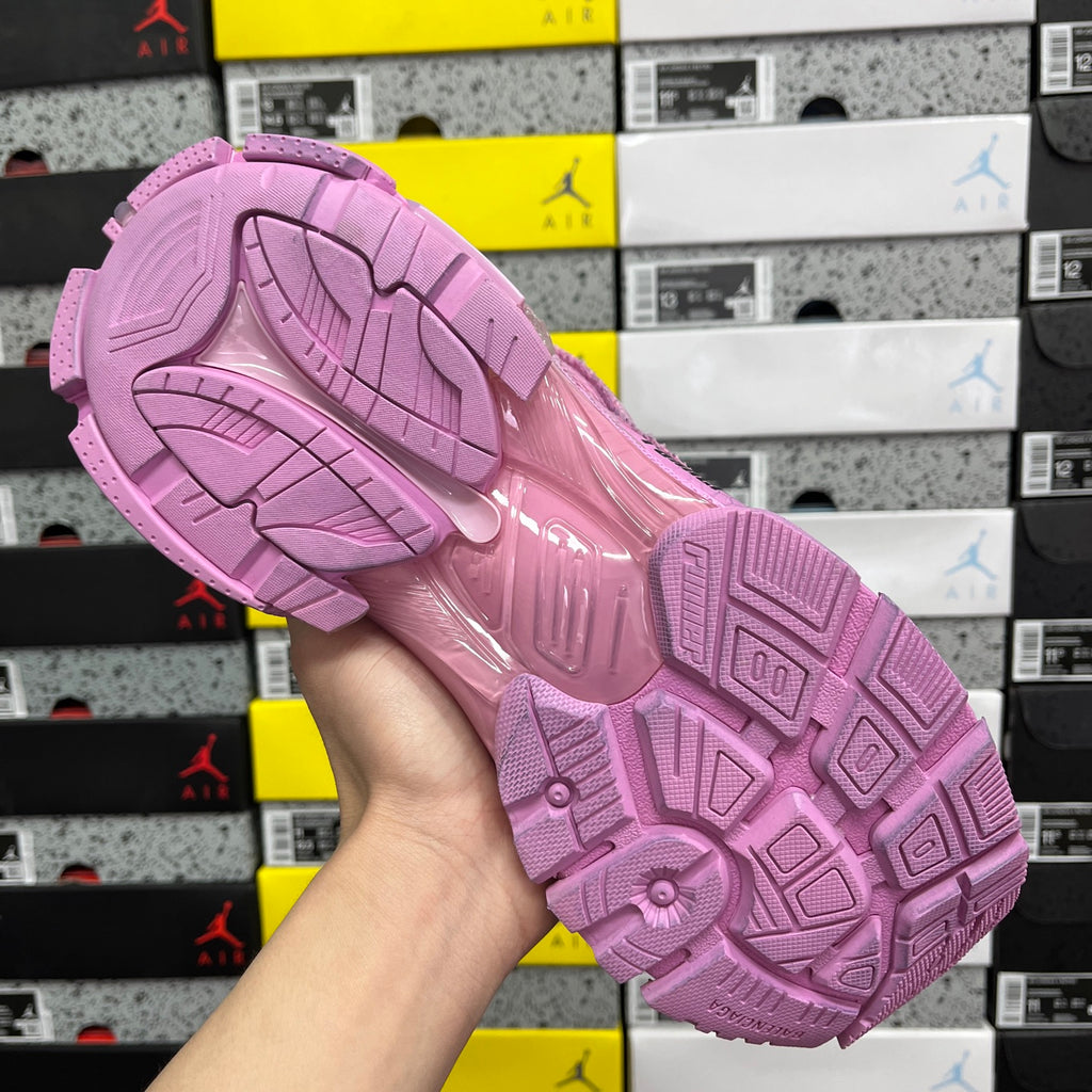 Pink rubber outsole with multidirectional tread pattern for grip.