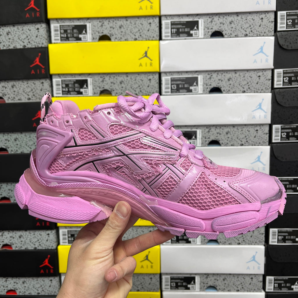 Pink mesh lace-up sneaker with layered panels and chunky midsole.