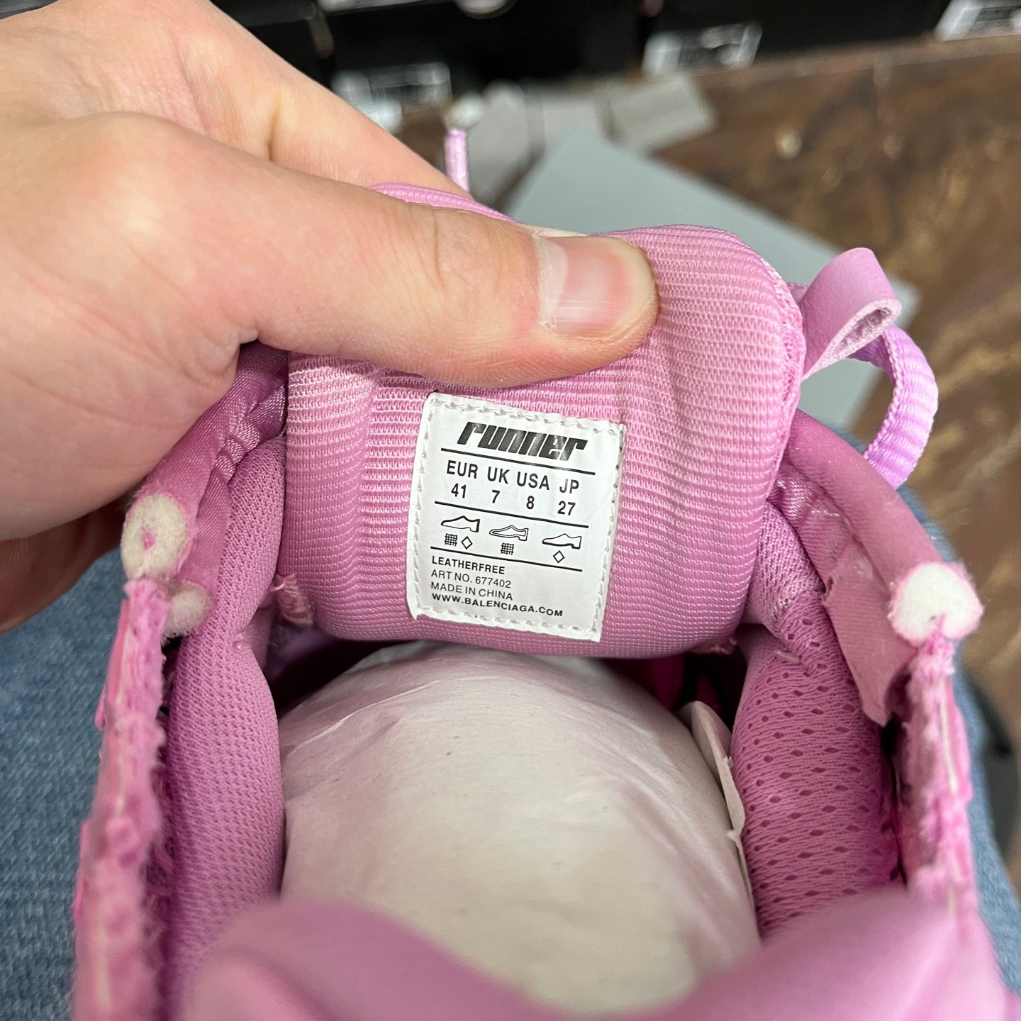 Pink sneaker inner label showing EU, UK, US, and JP sizing details.