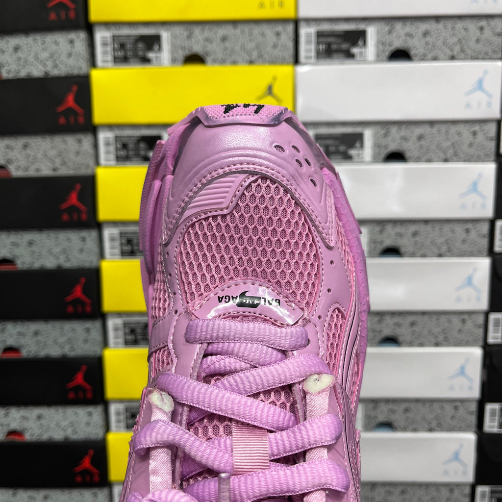 Pink sneaker heel with lace-up opening and textured mesh upper.