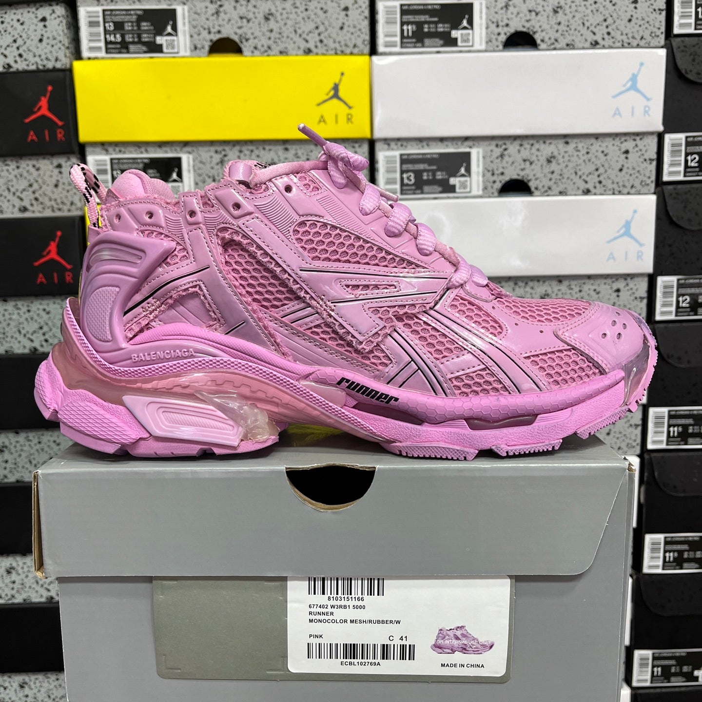 Pink mesh lace-up sneaker, side panel detailing and thick cushioned sole.