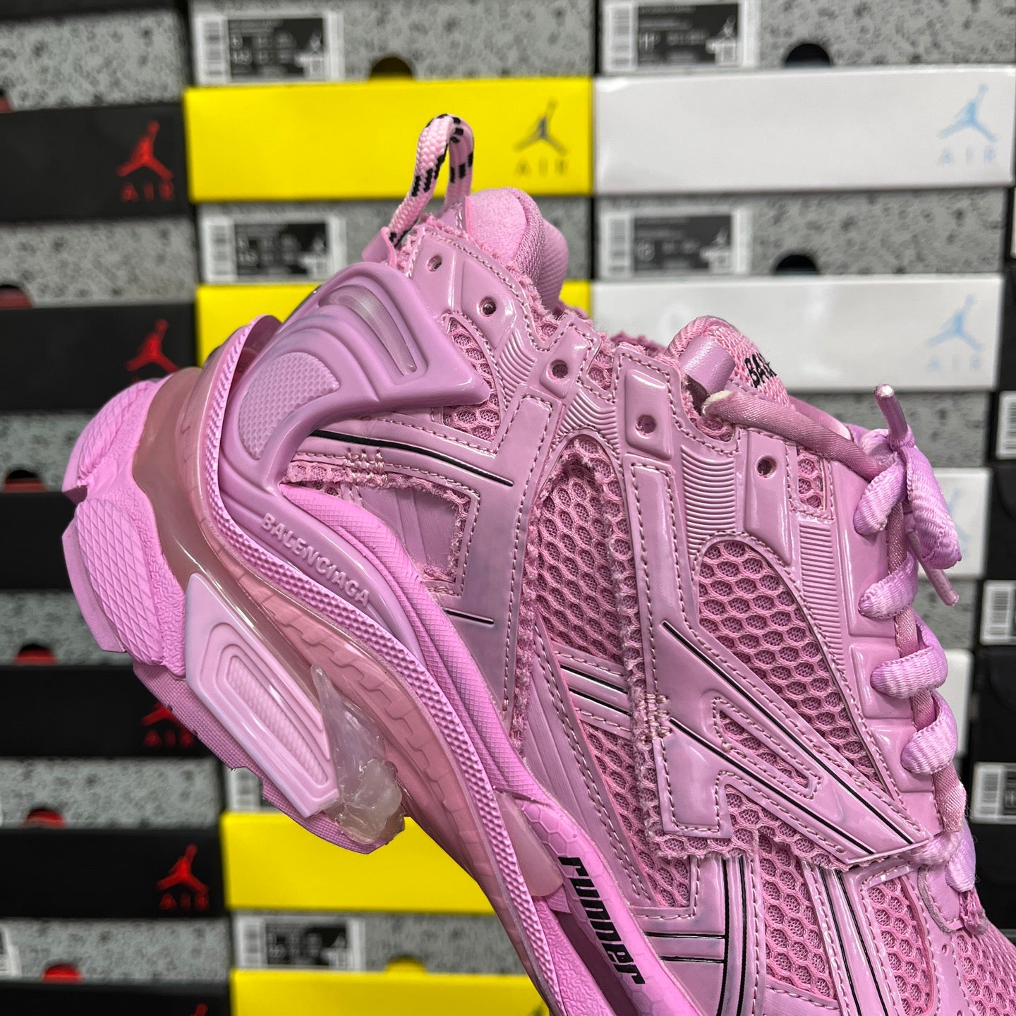 Pink lace-up sneaker with padded tongue and logo on side panel.