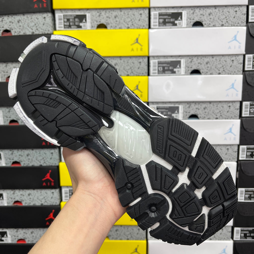 Black sneaker outsole with textured tread and thick midsole