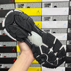 Black sneaker outsole with textured tread and thick midsole