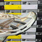 Balenciaga unisex sneakers in light gold and white with metallic logo stripe