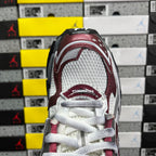 Balenciaga sneakers heel close-up with burgundy collar, white laces, rear logo patch