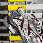 Balenciaga sneakers quarter view, silver upper with burgundy accents and white laces