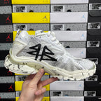 White Balenciaga sneakers with black graphic on side and chunky midsole