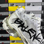 White Balenciaga sneakers with black graffiti logo and thick cushioned midsole
