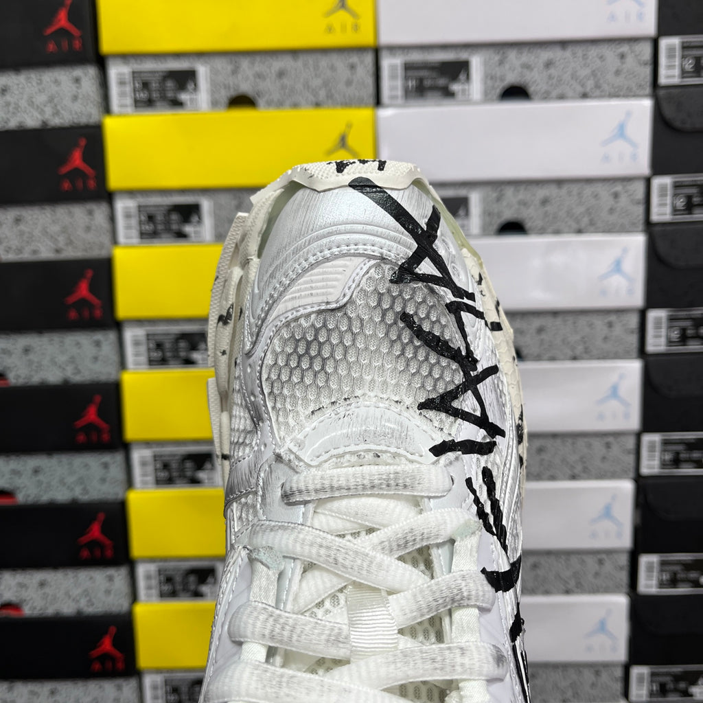 White Balenciaga sneakers with black logo on heel and white lace-up upper