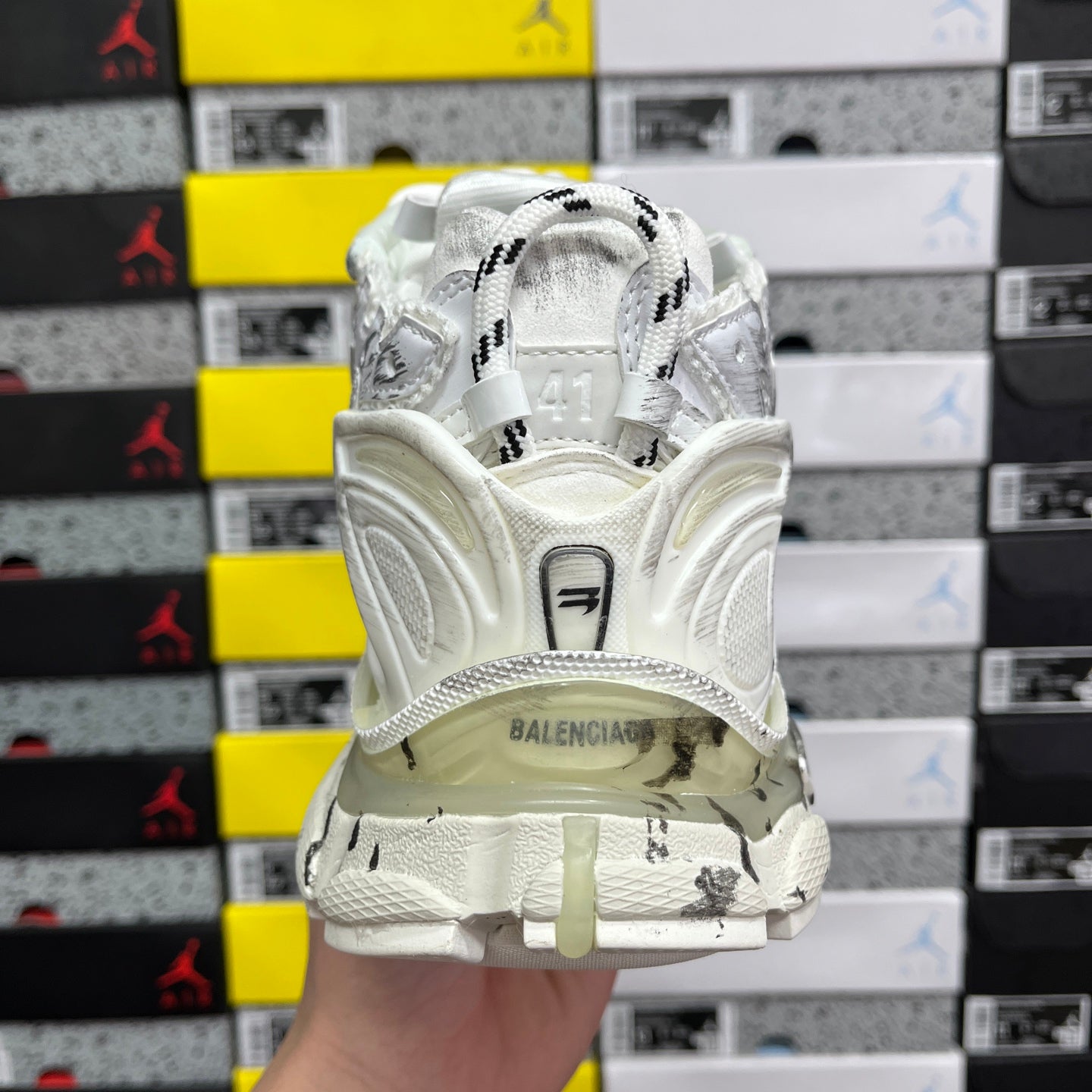 White Balenciaga sneakers with black logo on tongue and glossy heel panel