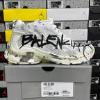 White Balenciaga sneakers with black graphic on side and cream-tinted sole