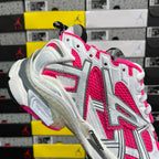 Chunky lace-up running sneakers with white uppers, hot pink highlights, and gray side vents