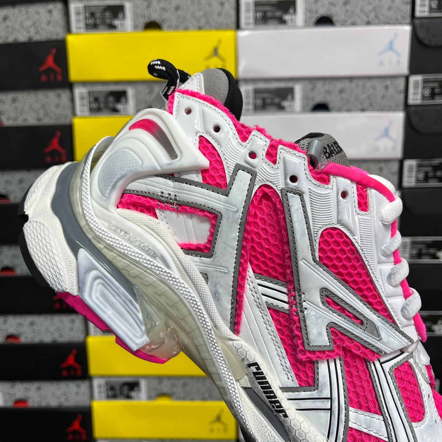 Chunky lace-up running sneakers with white uppers, hot pink highlights, and gray side vents