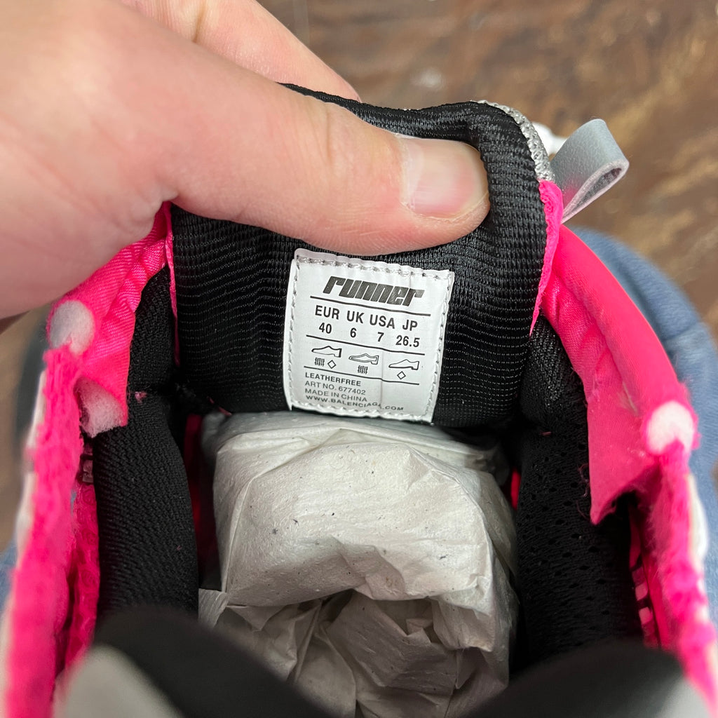 Size label and padded interior of running sneaker with black lining and pink trim