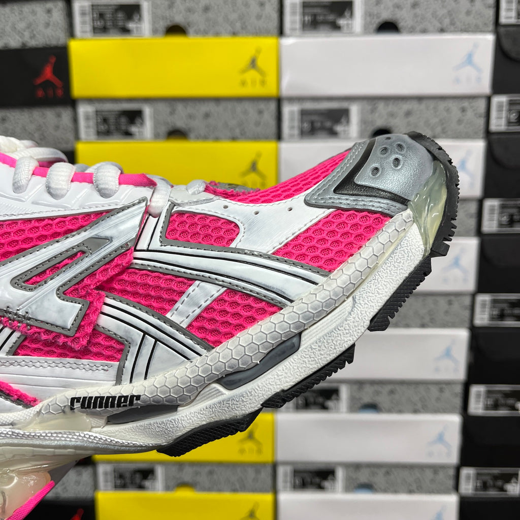 Lace-up running sneaker with white and hot pink upper and gray outsole tread
